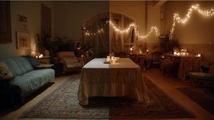 A cozy dinner party setting where layered lighting from candles and string lights creates a warm, intimate ambiance.