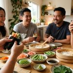 An ultra-photorealistic image of a joyful temaki hand roll gathering. Three to four friends or family members are actively assembling and enjoying fresh rolls, their hands focused on crisp nori, steaming sushi rice, glistening raw fish, avocado, and cucumber. A warm, inviting table is beautifully set with vibrant ingredients in small ceramic bowls. Soft, natural light illuminates the clean home setting, conveying connection and mindful enjoyment.