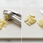 A photorealistic, top-down image on a light cutting board, visually comparing two garlic preparation methods. The left half shows a wet, pulpy pile of aggressively crushed garlic from a press. The right half displays finely minced and thinly sliced garlic cloves, neatly arranged next to a sharp chef's knife.