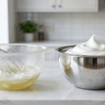 A photorealistic studio shot comparing two mixing bowls on a pristine kitchen counter. On the left, a scuffed plastic bowl holds a deflated, watery egg white mixture with a whisk partially submerged. On the right, a gleaming stainless steel bowl contains perfectly whipped, stiff, glossy egg white peaks, with a whisk resting on its rim, highlighting the stark contrast.